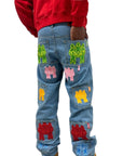 Blue jeans with colorful patches on a white background
